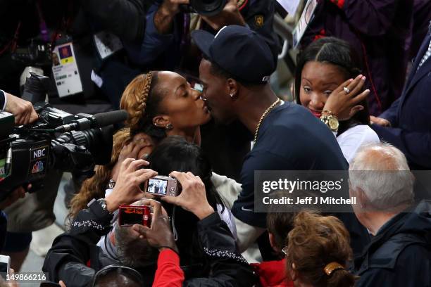 Sanya Richards-Ross of the United States kisses her husband and NFL Cornerback Aaron Ross after winning the Women's 400m final on Day 9 of the London...
