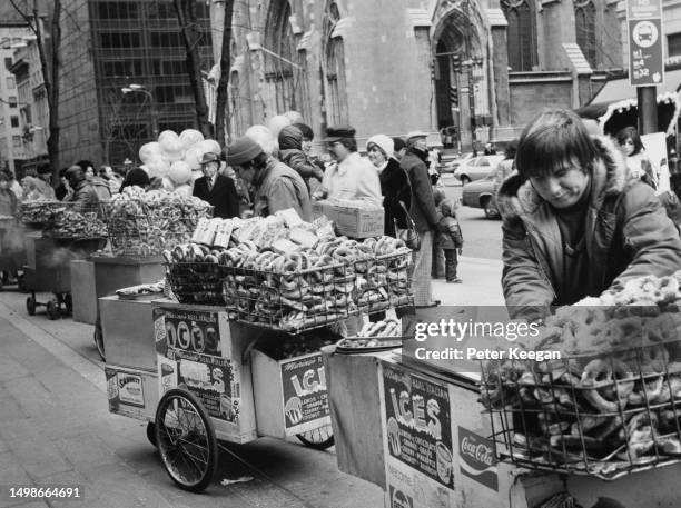 Pushcart vendors with their carts of 'Real Italian Ices', with baskets of pretzels on the top, parked along a street in the borough of Manhattan, New...
