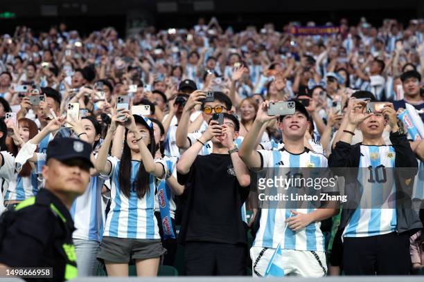 Chinese fans of Argentina take photographs with their mobile phones prior to the international friendly match between Argentina and Australia at...