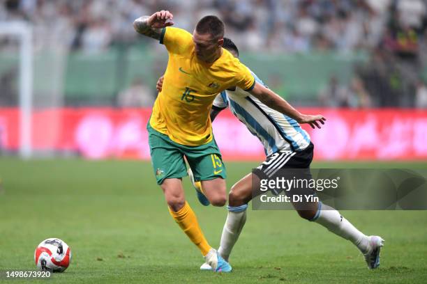Mitchell Duke of Australia controls the ball against Cristian Romero of Argentina during the international friendly match between Argentina and...