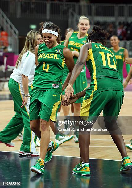 Adriana Pinto of Brazil is spanked by teammates to honor her final game with the Brazil National Team follwoing the Women's Basketball Preliminary...