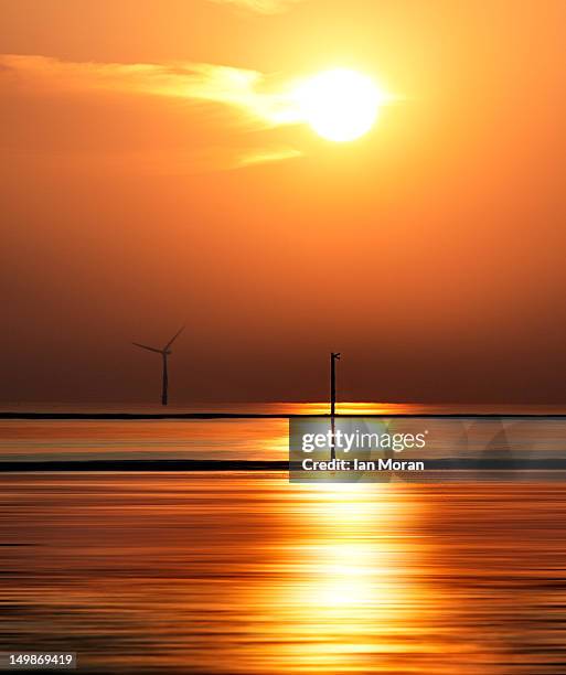 sunset on mile marker beach and wind turbine - sunset at burbo bank windfarm stock pictures, royalty-free photos & images