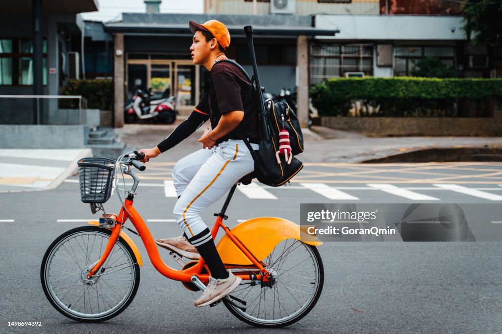 Baseball players happily to riding a bicycles  back to school on the street