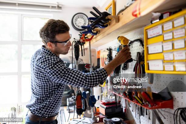 man working on a diy project in his workshop - building model airplane stock pictures, royalty-free photos & images