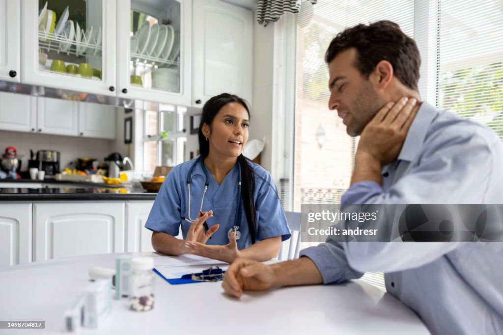 Man talking to the doctor about his neck pain on a house call