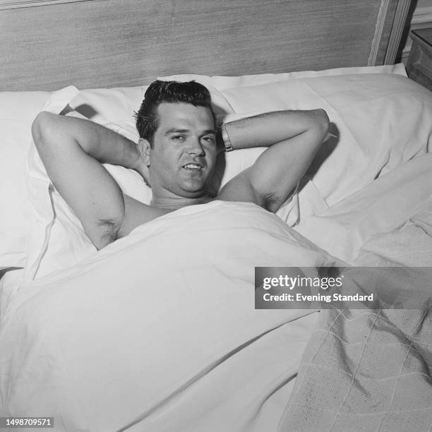 American singer Conway Twitty poses in his hotel bed, London, May 11th 1959.