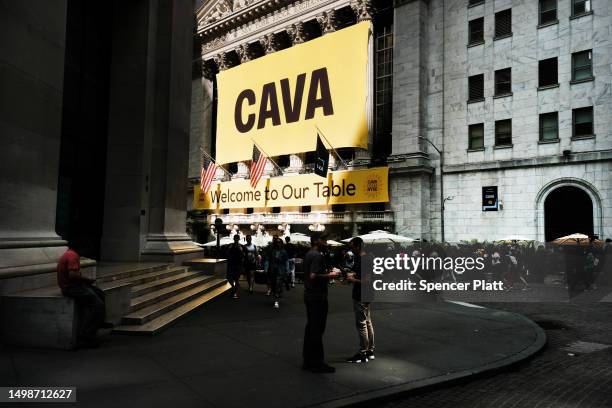Banner for the Mediterranean restaurant chain Cava is displayed outside of the New York Stock Exchange as the company goes public on June 15, 2023 in...