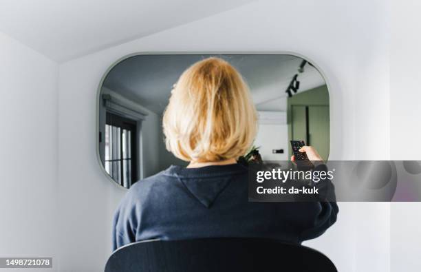 turning on mirror tv in living room - new broadcasting house stock pictures, royalty-free photos & images