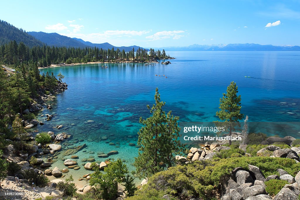 Lake Tahoe scene showing trees rocks and blue water