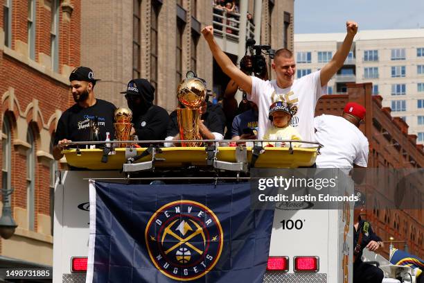 Jamal Murray and Nikola Jokic wave to fans during the Denver Nuggets victory parade and rally after winning the 2023 NBA Championship on June 15,...