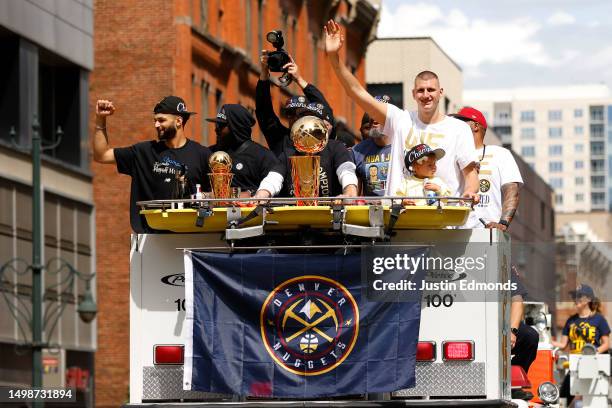 Jamal Murray and Nikola Jokic wave to fans during the Denver Nuggets victory parade and rally after winning the 2023 NBA Championship on June 15,...