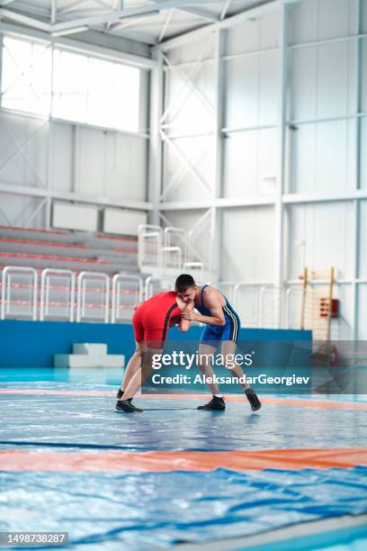wrestlers trying to dictate the pace of the fight - wrestling team stock pictures, royalty-free photos & images