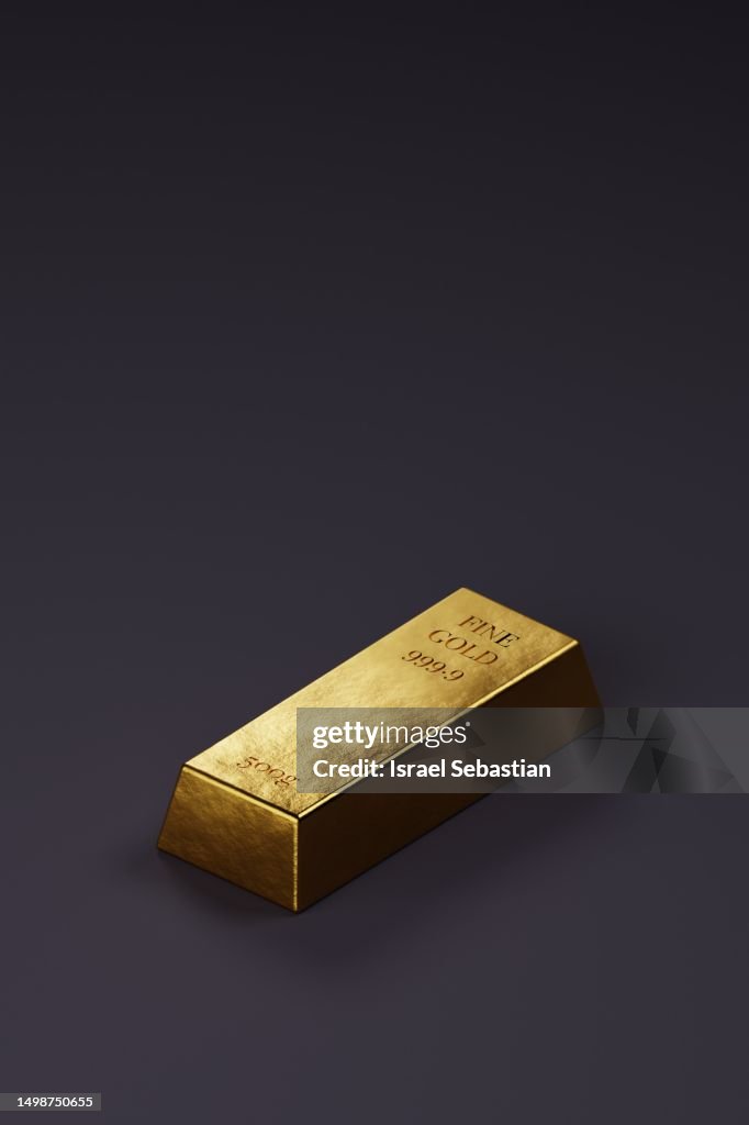 Gold bullion on dark purple background isolated. With copy space on the top.