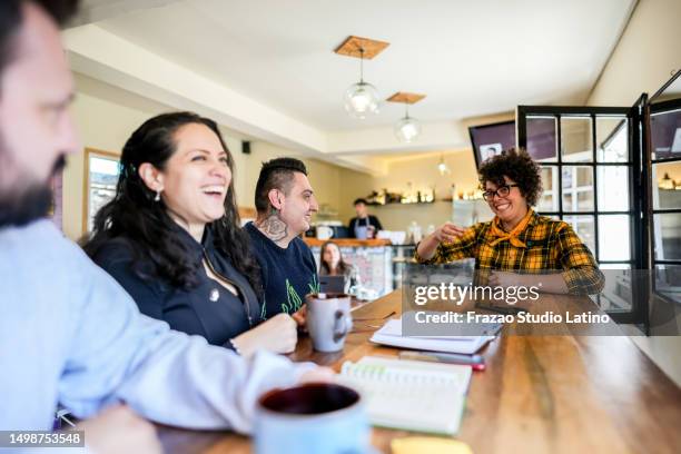 colleagues doing a language sign class at a coffee shop - group of people using sign language stock pictures, royalty-free photos & images