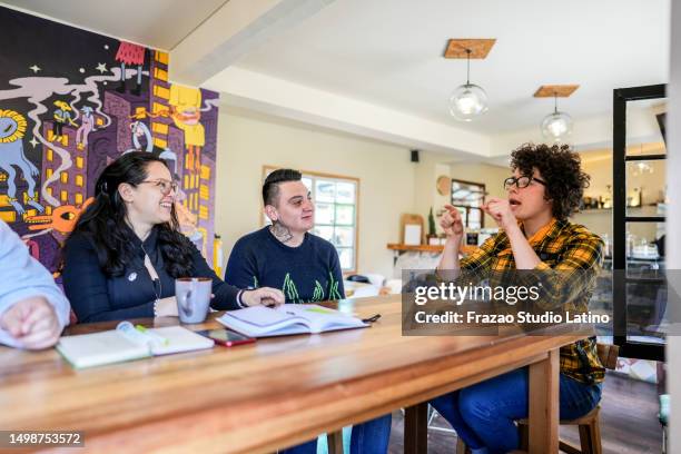 colleagues doing a language sign class at a coffee shop - group of people using sign language stock pictures, royalty-free photos & images