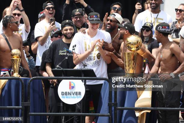 Jamal Murray, Nikola Jokic and Jeff Green react on state during the Denver Nuggets victory parade and rally after winning the 2023 NBA Championship...