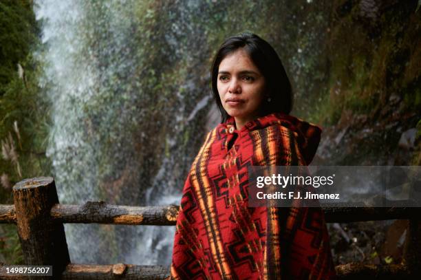 woman with andean ruana next to waterfall - pasto stock pictures, royalty-free photos & images