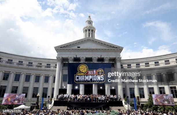 The Denver Nuggets celebrate during the Denver Nuggets victory parade and rally after winning the 2023 NBA Championship at Civic Center Park on June...