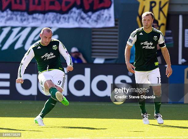 Kris Boyd shoots as Jack Jewsbury of Portland Timbers watches in the first half during the MLS match against FC Dallas at Jeld-Wen Field on August 5,...