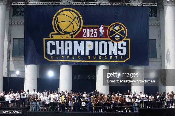 The Denver Nuggets celebrate during the Denver Nuggets victory parade and rally after winning the 2023 NBA Championship at Civic Center Park on June...