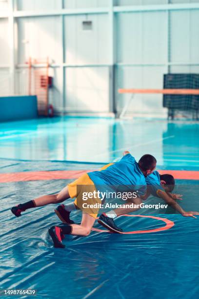 wrestling child trying to take opponent's back - wrestling stock pictures, royalty-free photos & images