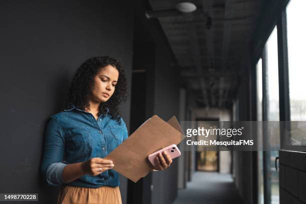 woman reading work plan - flyers business people bildbanksfoton och bilder