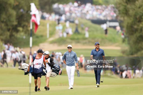 Rickie Fowler of the United States and Jason Day of Australia walk up the seventh hole during the first round of the 123rd U.S. Open Championship at...
