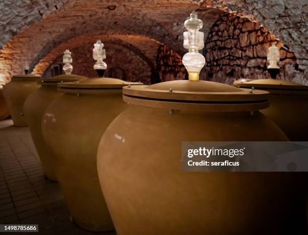 wine aging in modern clay amphorae in a wine cellar - amphora stock pictures, royalty-free photos & images