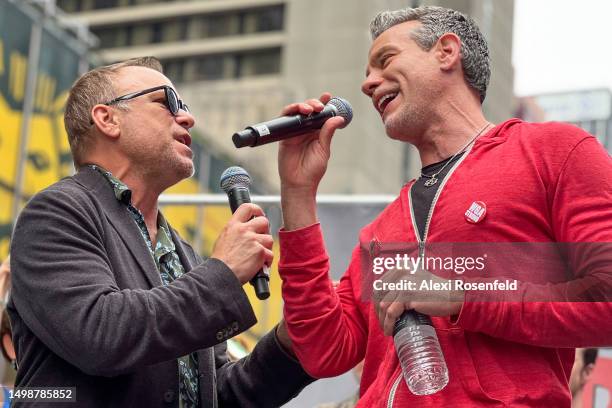 Actors Norbert Leo Butz and Adam Pascal sing during the 'Broadway Day Rally' hosted by the Writers Guild of America East in Times Square on June 15,...