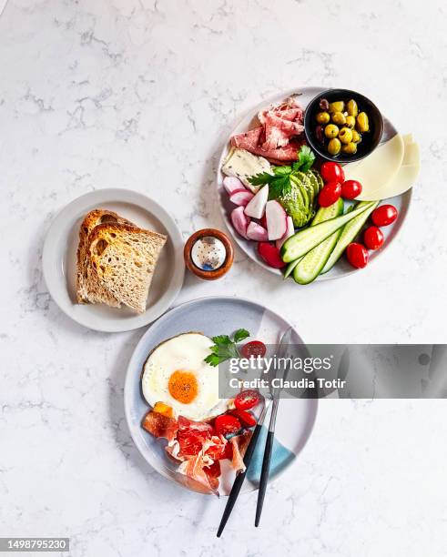 breakfast with fried egg, ham, vegetables, and a glass of orange juice on white background - salt and pepper shaker overhead stock pictures, royalty-free photos & images