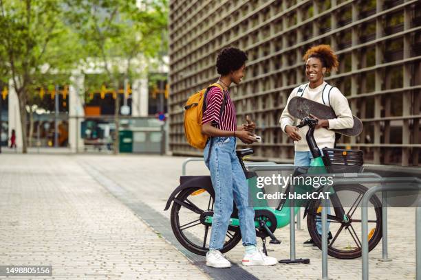 urban young people hanging out in the city. gen z lifestyle - bicycle rental stock pictures, royalty-free photos & images