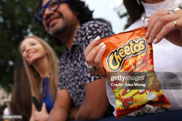 Woman holds bag of Flamin' Hot Cheetos during a screening of the film “Flamin’ Hot,” hosted by U.S. President Joe Biden and first lady Jill Biden on...