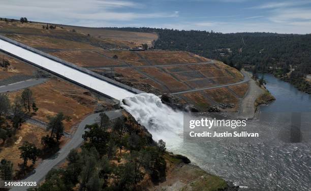 In an aerial view, water is released on the main spillway at Lake Oroville on June 15, 2023 in Oroville, California. After several winter storms that...