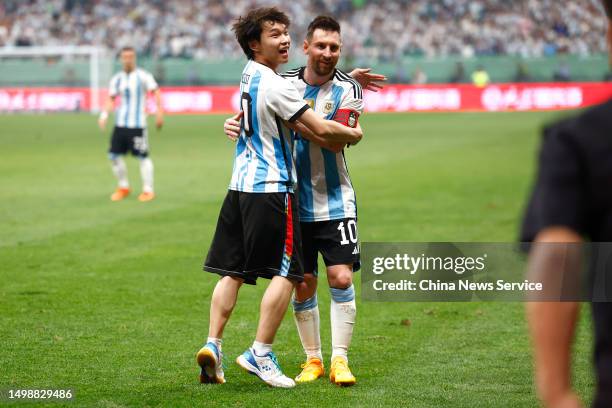 Fan hugs Lionel Messi of Argentina during the international friendly match between Argentina and Australia at Workers Stadium on June 15, 2023 in...