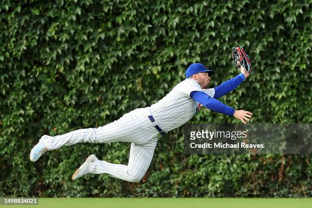 Ian Happ of the Chicago Cubs makes a diving catch against the Pittsburgh Pirates during the fourth inning at Wrigley Field on June 15, 2023 in...