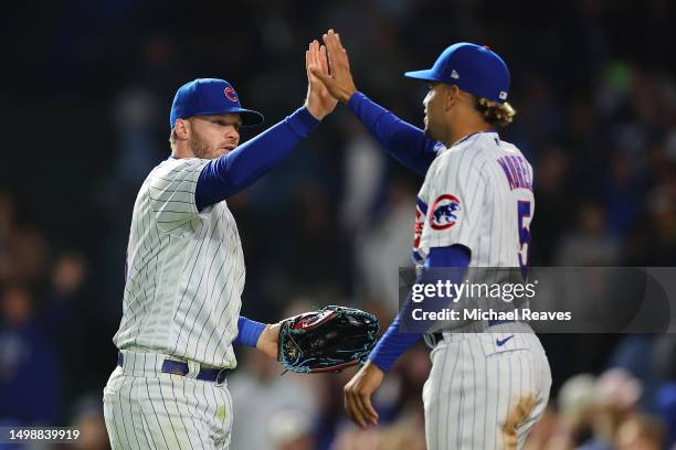 Ian Happ and Christopher Morel of the Chicago Cubs celebrate after defeating the Pittsburgh Pirates 7-2 at Wrigley Field on June 15, 2023 in Chicago,...