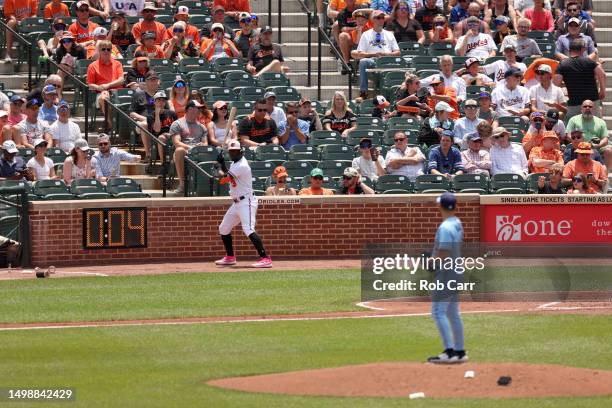 Jorge Mateo of the Baltimore Orioles waits in the on deck circle next to the pitch clock as pitcher Yusei Kikuchi of the Toronto Blue Jays waits to...