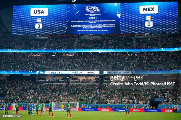 The video board displays a message that the game has been stopped due to discriminatory chanting during the second half of the 2023 CONCACAF Nations...