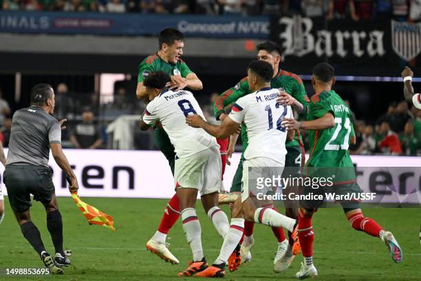 César Montes of Mexico is shoved by Weston McKennie of the United States in the second half during the 2023 CONCACAF Nations League Semifinal at...