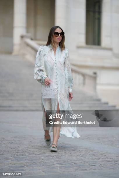 Maria Rosaria Rizzo wears brown marble print pattern sunglasses from Isabel Marant, silver earrings, a white and pale blue marble print pattern silk...