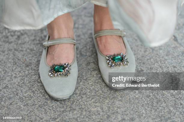 Maria Rosaria Rizzo wears pale gray suede ballerinas with an embroidered green emerald stones buckle on the toe-cap , during a street style fashion...