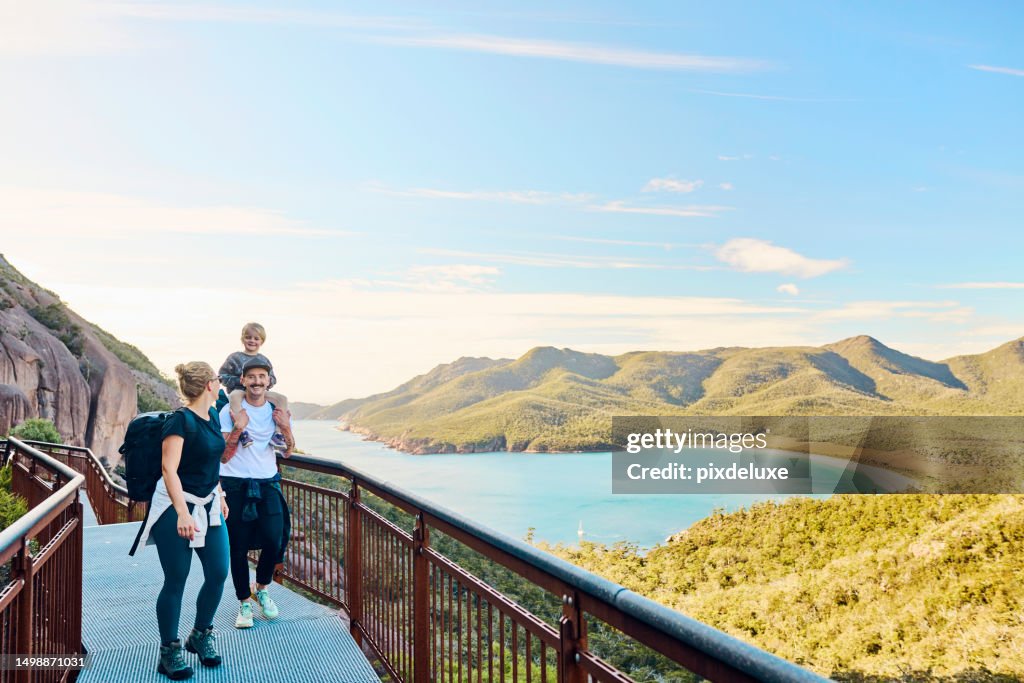 Worth the walk: Bushwalking young family in Tasmania, Australia taking in the view at Freycinet NP.