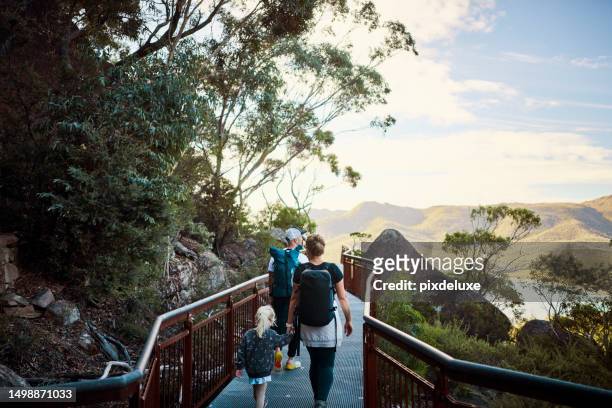 young active family with a toddler bushwalking outside in the beautiful freycinet national park. - family holidays australia stock pictures, royalty-free photos & images