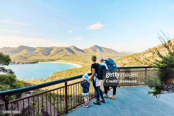 worth the walk: bushwalking young family in tasmania, australia taking in the view at freycinet np. - tasmania stock pictures, royalty-free photos & images