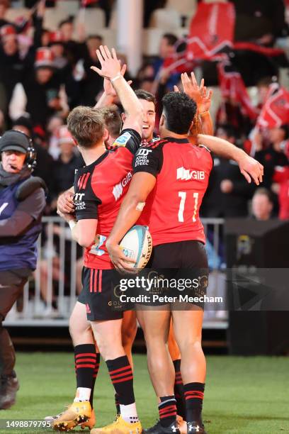 Crusaders team mates celebrate with Leicester Fainga'anuku, right, of the Crusaders after he scored a try during the Super Rugby Pacific Semi Final...