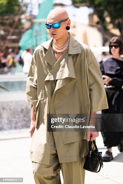 Guest, wearing Oakley sunglasses and green jacket, is seen at Fortezza Da Basso during Pitti Immagine Uomo 104 on June 15, 2023 in Florence, Italy.