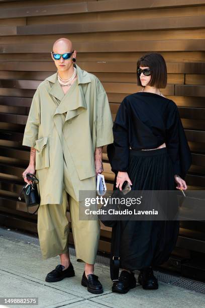 Guests, wearing Oakley sunglasses and green jacket and pants and black skirt and t-shirt, are seen at Fortezza Da Basso during Pitti Immagine Uomo...