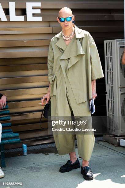 Guest, wearing Oakley sunglasses and green jacket and pants, is seen at Fortezza Da Basso during Pitti Immagine Uomo 104 on June 15, 2023 in...