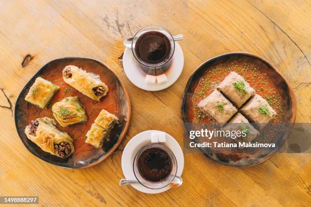 turkish tea and delight in plates on wooden table, top view. - sweet food stock pictures, royalty-free photos & images