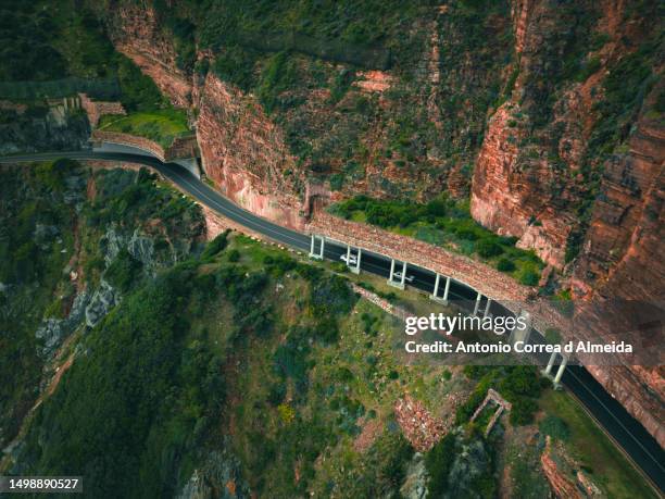 aerial image of chapman's peak drive along the cape peninsula in south africa - chapmans peak stock pictures, royalty-free photos & images